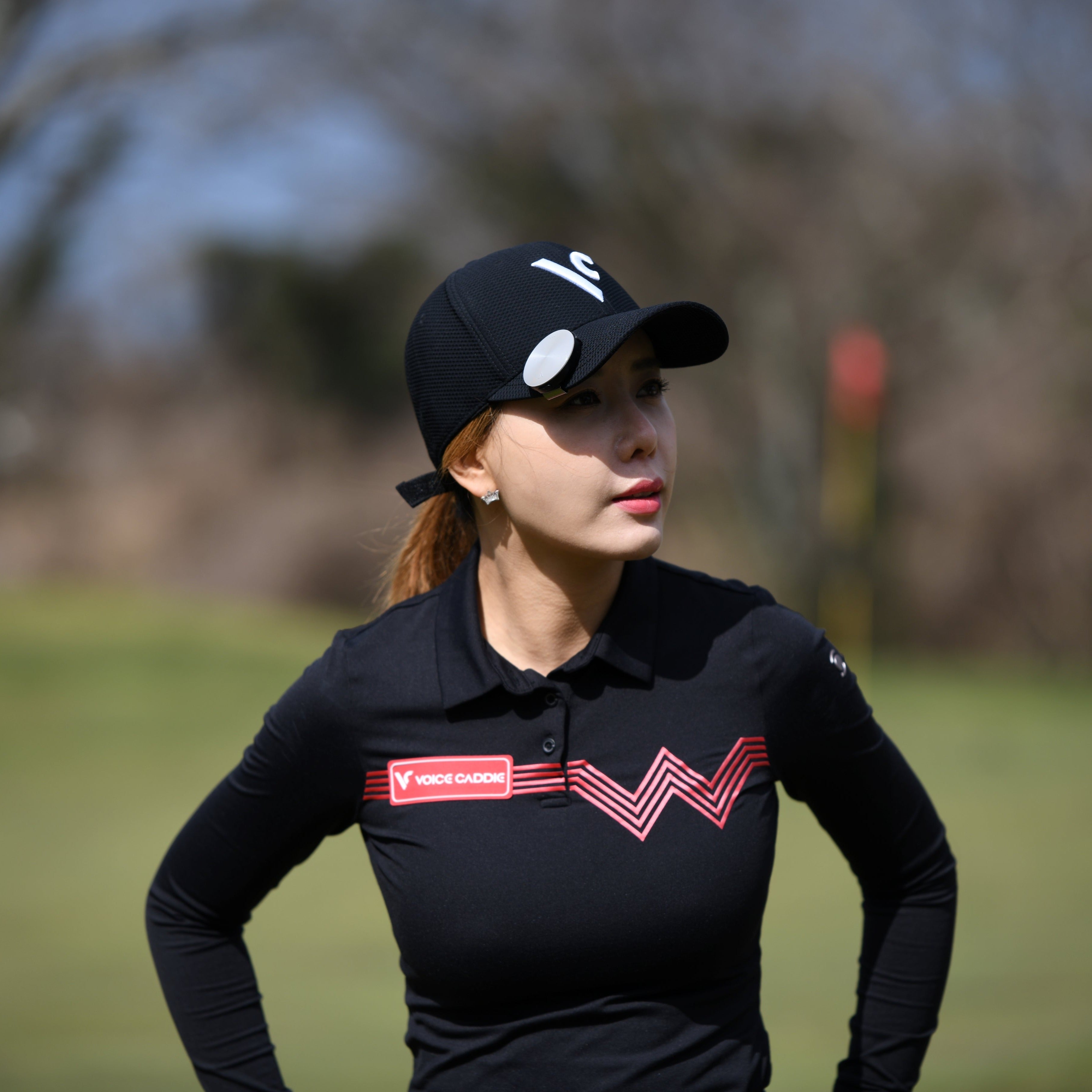 asian woman wearing voice caddie gray vc4 on black hat